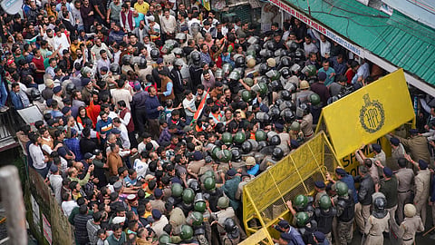 Protesters try to break through the police barricades | 